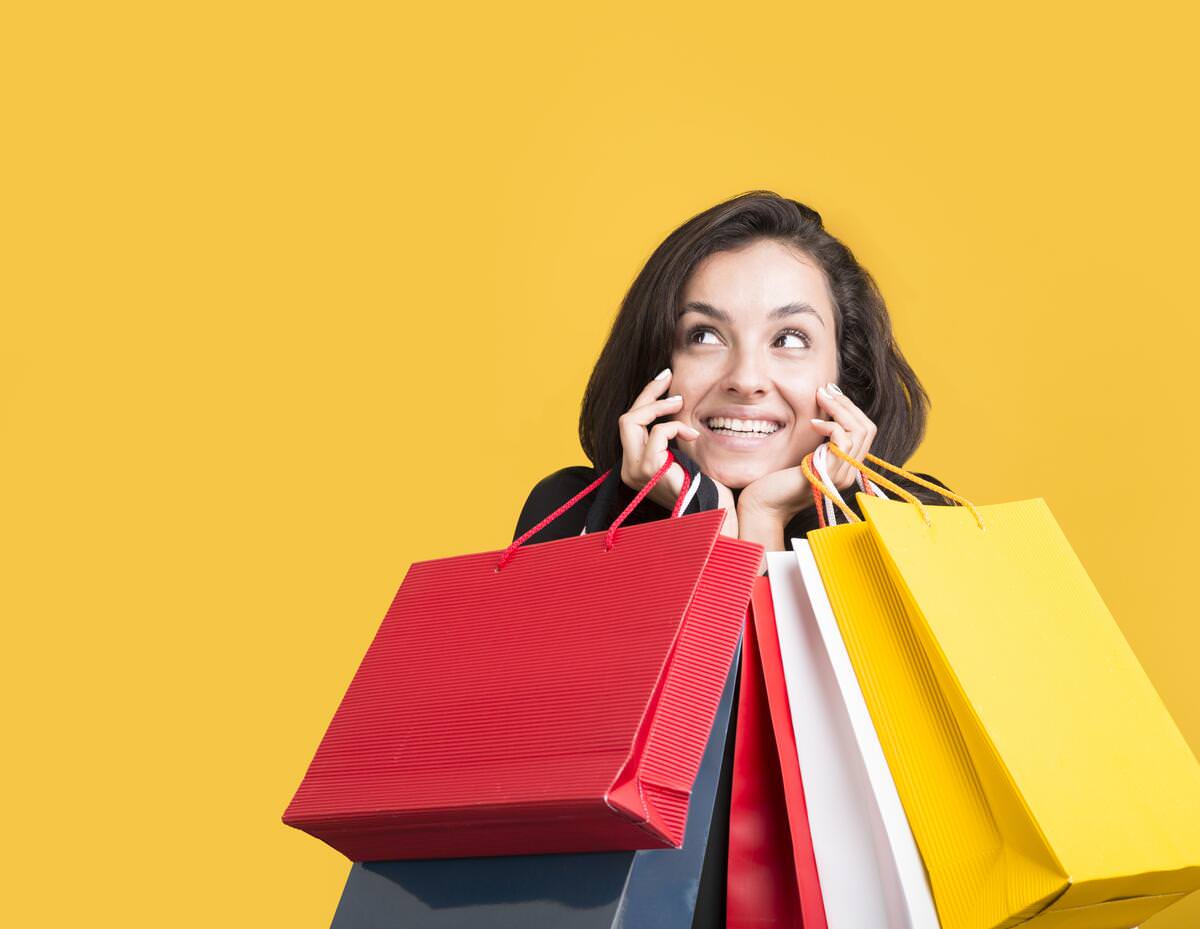 black friday sale model being covered by shopping bags