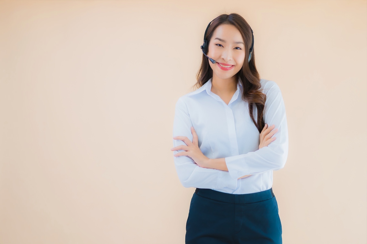 portrait beautiful young asian business woman with headphone call center